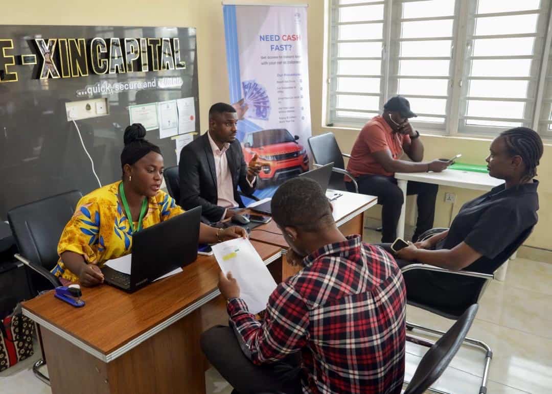E-XIN Capital team attending to a customer at their Ikeja office